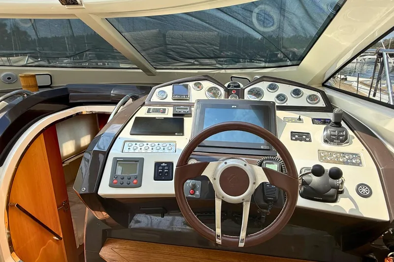  Yacht Photos Pics Cockpit of 2007 Absolute 56 HT yacht with steering wheel and navigation controls.