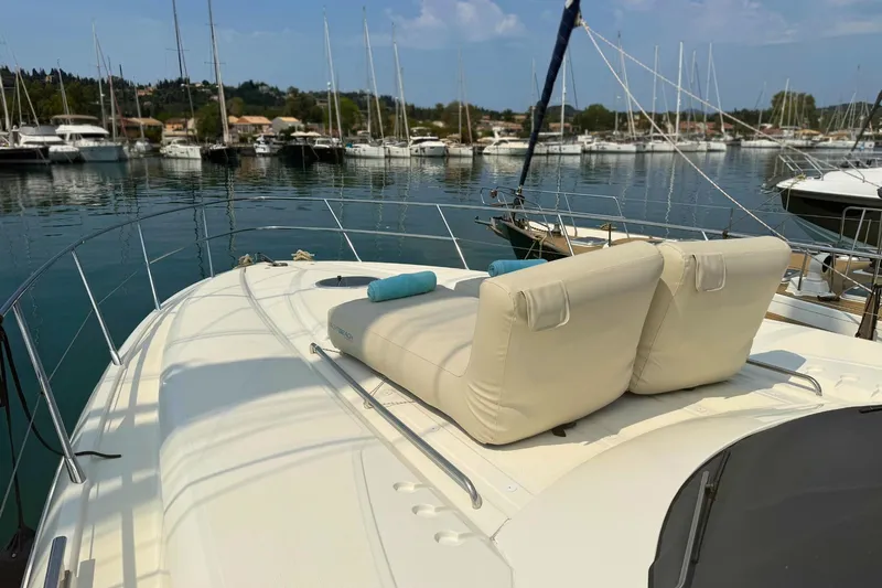  Yacht Photos Pics Luxury yacht Absolute 56 HT (2007) with sun loungers, docked in a serene marina.