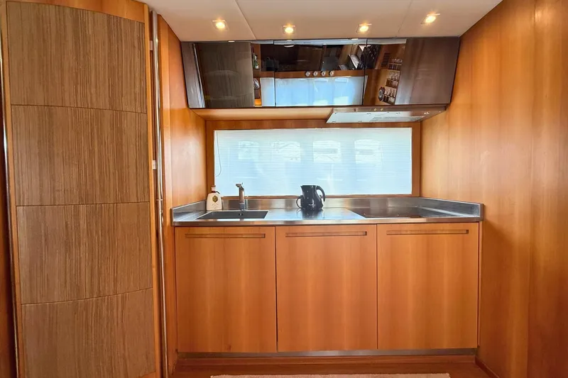  Yacht Photos Pics Luxurious wooden kitchen interior of 2007 Absolute 56 HT yacht, featuring modern appliances.