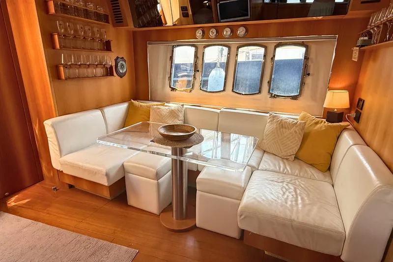  Yacht Photos Pics Luxurious interior of 2007 Absolute 56 HT yacht with white seating and glass table.