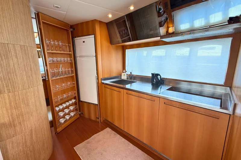  Yacht Photos Pics Luxurious kitchen interior of 2007 Absolute 56 HT yacht with wooden cabinetry and modern appliances.