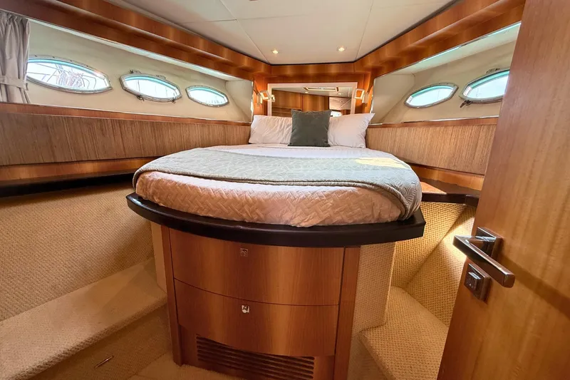  Yacht Photos Pics Luxurious cabin interior of 2007 Absolute 56 HT yacht with cozy bed and elegant wood finish.