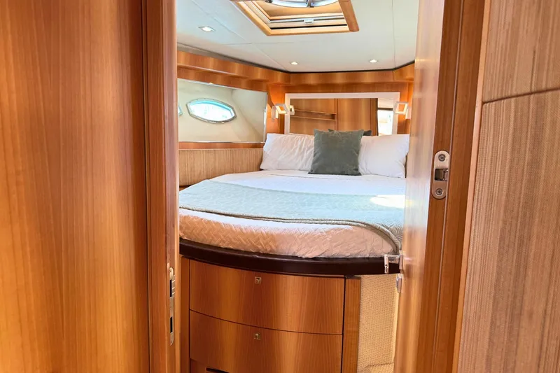  Yacht Photos Pics Luxurious cabin interior of 2007 Absolute 56 HT yacht with cozy bed and wooden finish.