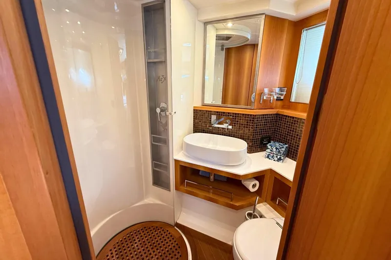  Yacht Photos Pics Luxurious bathroom in 2007 Absolute 56 HT yacht with modern fixtures and wood accents.