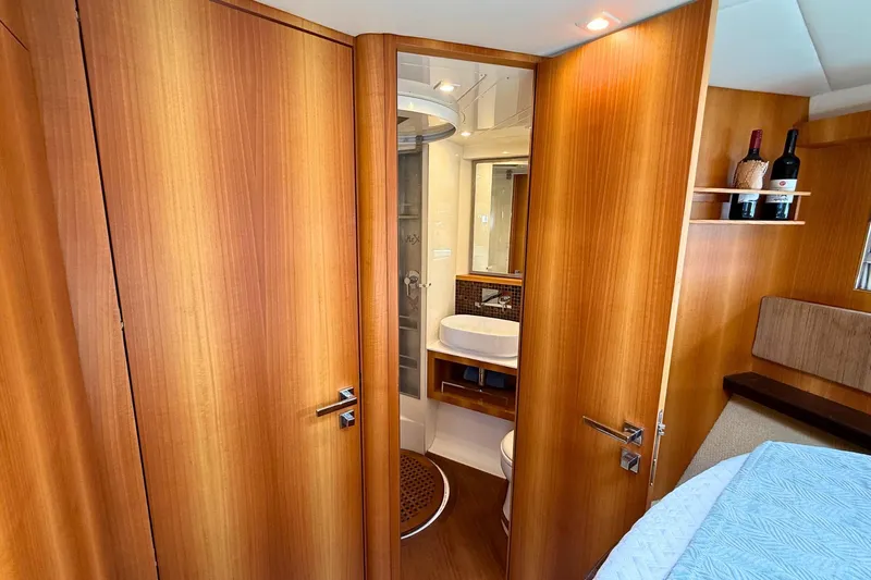  Yacht Photos Pics Luxurious 2007 Absolute 56 HT yacht interior with wooden finish and modern bathroom.
