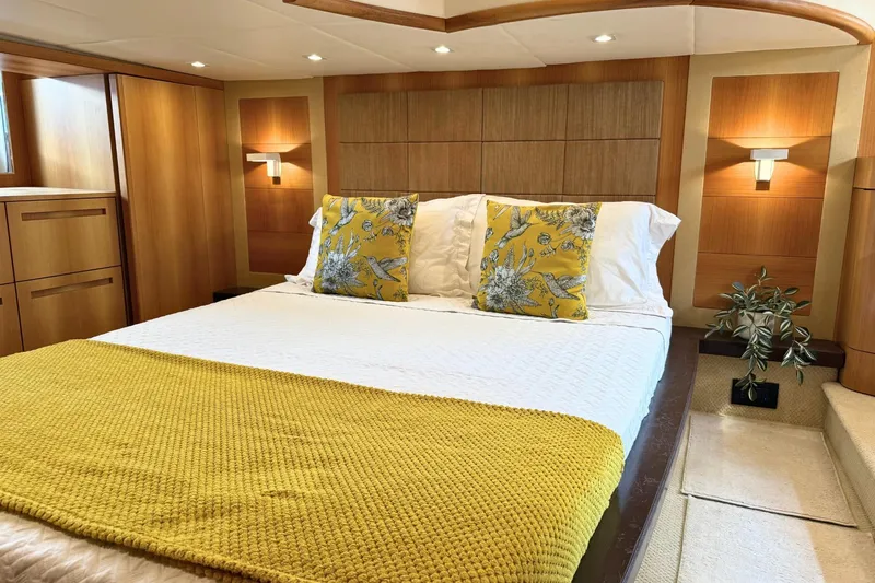  Yacht Photos Pics Luxurious bedroom interior on 2007 Absolute 56 HT yacht with elegant wood paneling.