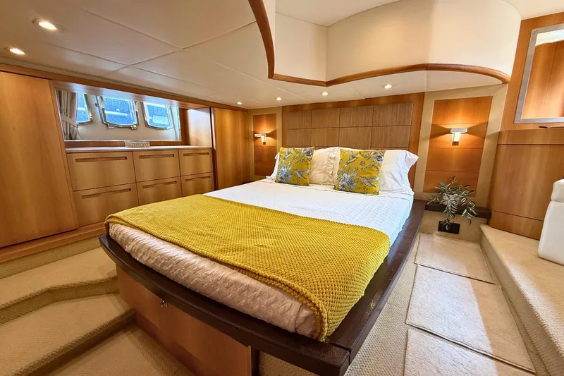  Yacht Photos Pics Luxurious bedroom interior of 2007 Absolute 56 HT yacht with elegant wood paneling.