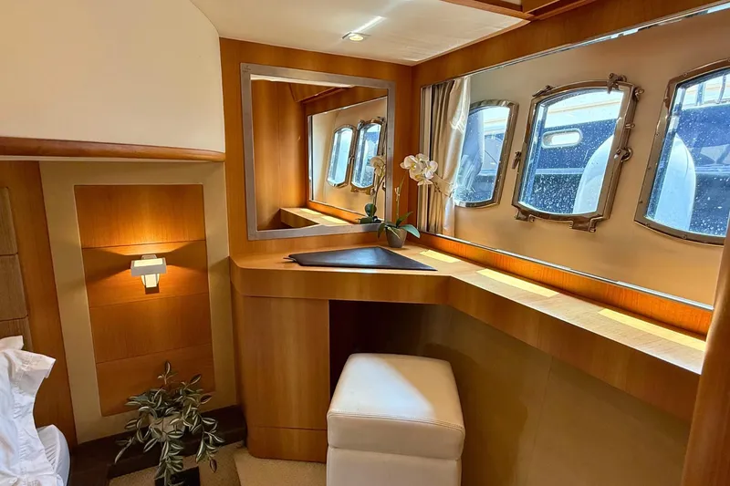  Yacht Photos Pics Luxurious interior of 2007 Absolute 56 HT yacht with elegant wood finish and porthole windows.