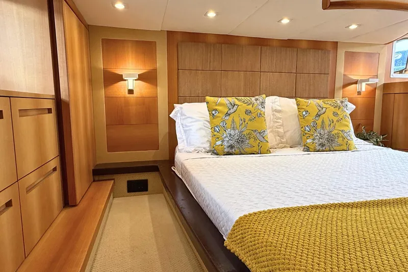  Yacht Photos Pics Luxurious bedroom interior of 2007 Absolute 56 HT yacht with elegant wood paneling.