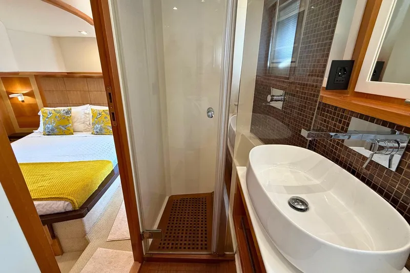  Yacht Photos Pics Luxurious 2007 Absolute 56 HT yacht interior with modern bathroom and cozy bedroom.