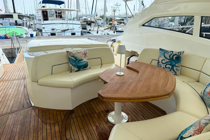  Yacht Photos Pics Luxurious 2007 Absolute 56 HT yacht interior with elegant seating and wooden table.
