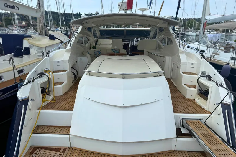  Yacht Photos Pics 2007 Absolute 56 HT yacht with spacious deck and luxurious seating in marina.