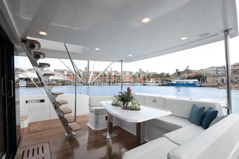  Yacht Photos Pics Luxurious 2026 Aventura 38 Motor Yacht with elegant deck seating and scenic harbor view.