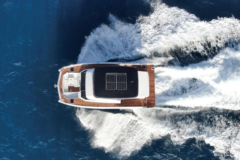  Yacht Photos Pics Aventura 38 Motor Yacht 2026 cruising on open blue sea, aerial view.