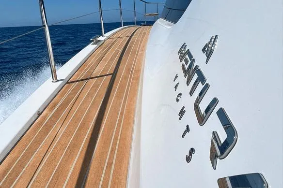  Yacht Photos Pics Aventura 38 Motor Yacht 2026 cruising on open sea with sleek wooden deck.