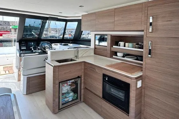  Yacht Photos Pics Modern kitchen interior of 2026 Aventura 38 Motor Yacht with wood cabinetry and appliances.
