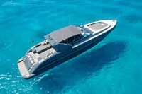 Luxury 2004 Mangusta 80 Open yacht cruising on clear blue waters.
