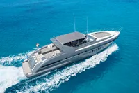 2004 Mangusta 80 Open yacht cruising on clear blue ocean waters.