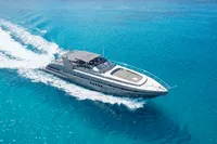 2004 Mangusta 80 Open yacht cruising on clear blue ocean waters.