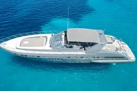 2004 Mangusta 80 Open yacht cruising on clear blue water.