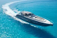 Luxury Mangusta 80 Open yacht cruising on clear blue waters, 2004 model.