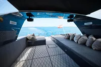 Luxurious 2004 Mangusta 80 Open yacht interior with plush seating and ocean view.