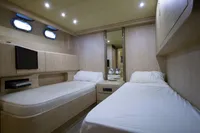 Luxurious twin cabin interior of 2004 Mangusta 80 Open yacht with modern amenities.