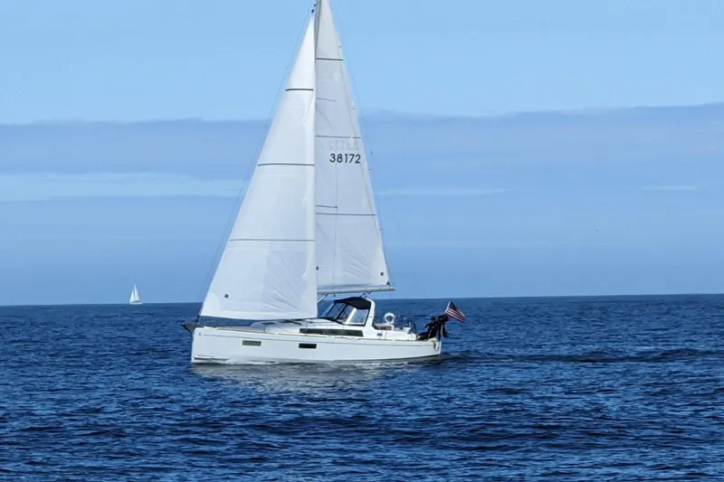 Grand Cru Yacht Photos Pics 2018 Beneteau Oceanis 38.1 sailboat cruising on open sea under clear blue sky.