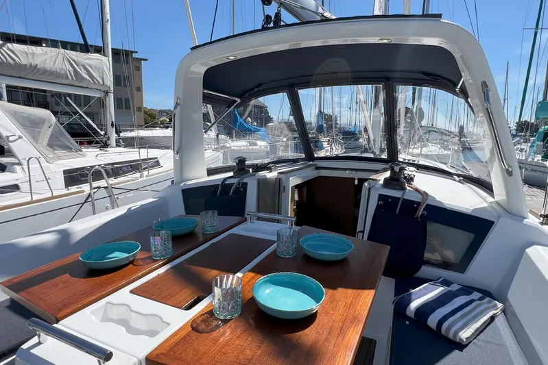Grand Cru Yacht Photos Pics Cockpit of 2018 Beneteau Oceanis 38.1 yacht with tableware and seating.