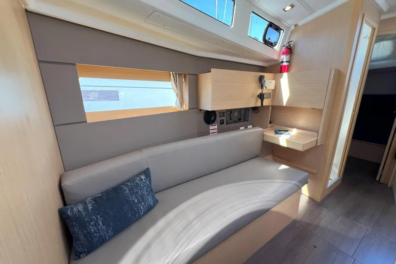 Grand Cru Yacht Photos Pics Interior of 2018 Beneteau Oceanis 38.1 yacht, featuring modern seating and wooden cabinetry.