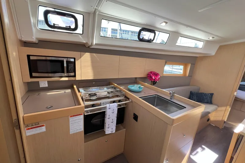 Grand Cru Yacht Photos Pics 2018 Beneteau Oceanis 38.1 yacht interior kitchen with modern amenities and natural light.