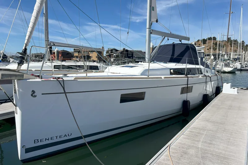 Grand Cru Yacht Photos Pics 2018 Beneteau Oceanis 38.1 sailboat docked at marina under clear blue sky.
