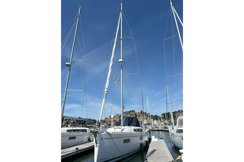 Grand Cru Yacht Photos Pics 2018 Beneteau Oceanis 38.1 sailboat docked in marina under clear blue sky.