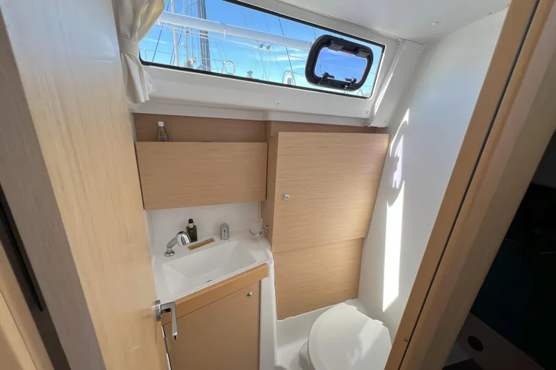 Grand Cru Yacht Photos Pics 2018 Beneteau Oceanis 38.1 bathroom with sink, toilet, and window view.