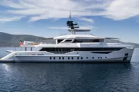 Luxurious 2023 Bilgin Custom yacht on calm sea with scenic mountain backdrop.