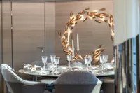 Luxurious dining area with elegant table setting and artistic wall decor, Bilgin Custom 2023.