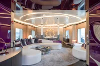 Luxurious yacht interior with modern design, featuring curved seating and elegant lighting, Bilgin Custom 2023.