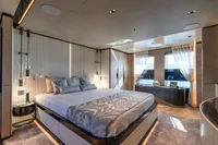 Luxurious yacht bedroom interior with modern design, featuring a large bed and elegant decor, 2023 Bilgin Custom.