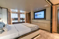 Luxurious bedroom interior in 2023 Bilgin Custom yacht with modern decor and large TV.