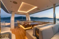 Luxurious 2023 Bilgin Custom yacht deck with elegant seating and ocean view at sunset.