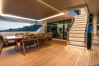 Luxurious 2023 Bilgin Custom yacht interior with elegant dining area and illuminated staircase.