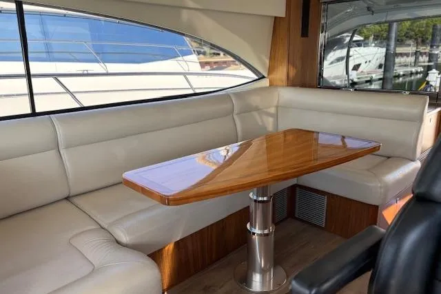  Yacht Photos Pics Luxurious interior of 2020 Riviera 4800 Sport Yacht with elegant seating and wooden table.