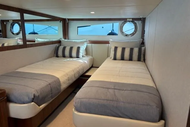  Yacht Photos Pics 2020 Riviera 4800 Sport Yacht cabin with twin beds and nautical decor.