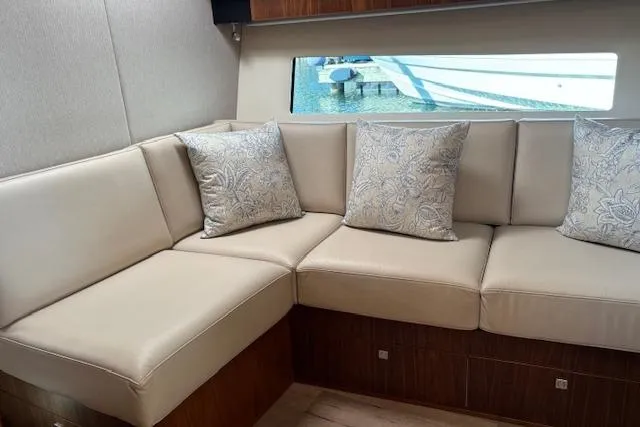  Yacht Photos Pics Luxurious interior of 2020 Riviera 4800 Sport Yacht with elegant beige seating and cushions.