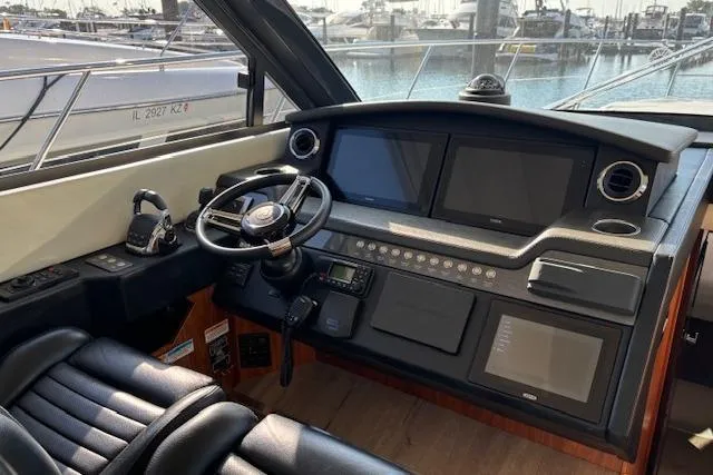  Yacht Photos Pics 2020 Riviera 4800 Sport Yacht helm with modern navigation displays and luxurious seating.