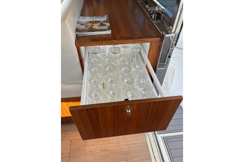 Yacht Photos Pics Wooden drawer with glassware in a 2020 Riviera 4800 Sport Yacht interior.