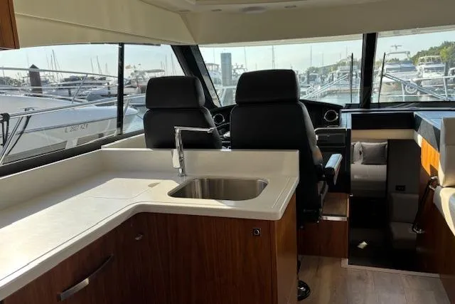  Yacht Photos Pics Interior of 2020 Riviera 4800 Sport Yacht with modern kitchen and helm station.