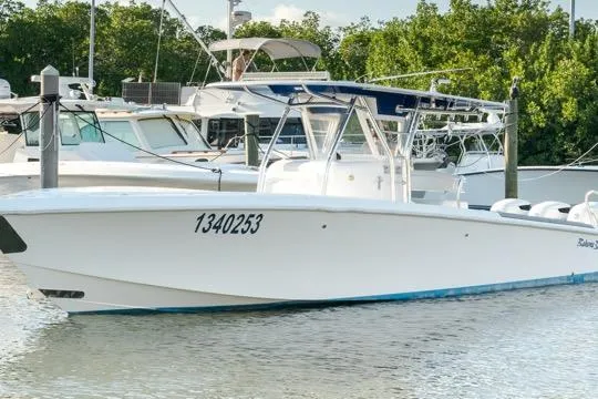  Yacht Photos Pics A 2015 Bahama 34 boat docked in a marina with surrounding greenery.
