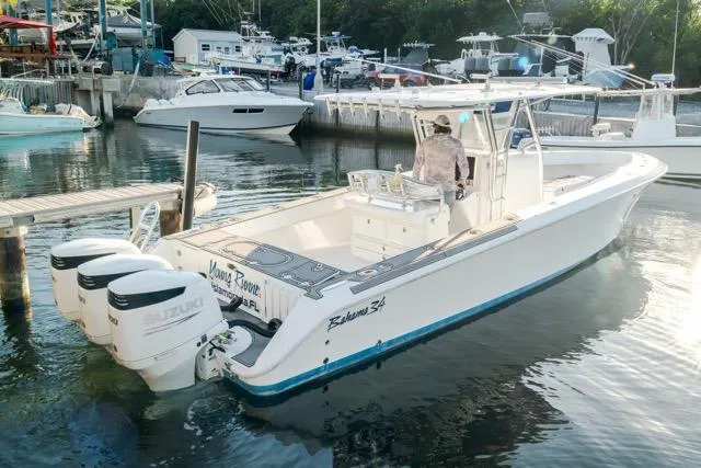  Yacht Photos Pics 2015 Bahama 34 boat with triple Suzuki engines docked in a marina.