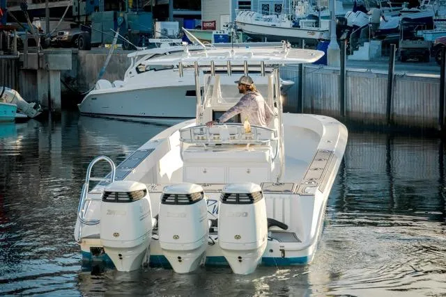  Yacht Photos Pics 2015 Bahama 34 boat with triple engines docked in a marina.